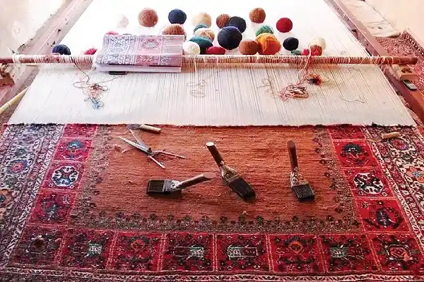 Traditional Afghan carpet with red geometric patterns